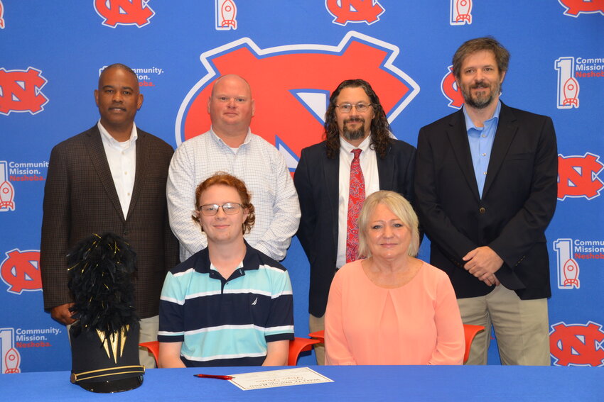 Neshoba Central’s Bryce Parker signed with East Central Community College to further his education and be a member of the Wall O’ Sound Band. Pictured, from left, are his mother, Elyce Parker and Bryce Parker (Back) Assistant Principal LaShon Horne, Assistant Principal Brent Pouncy, Band Director Daniel Wade, and ECCC Representative Justin Sharp.